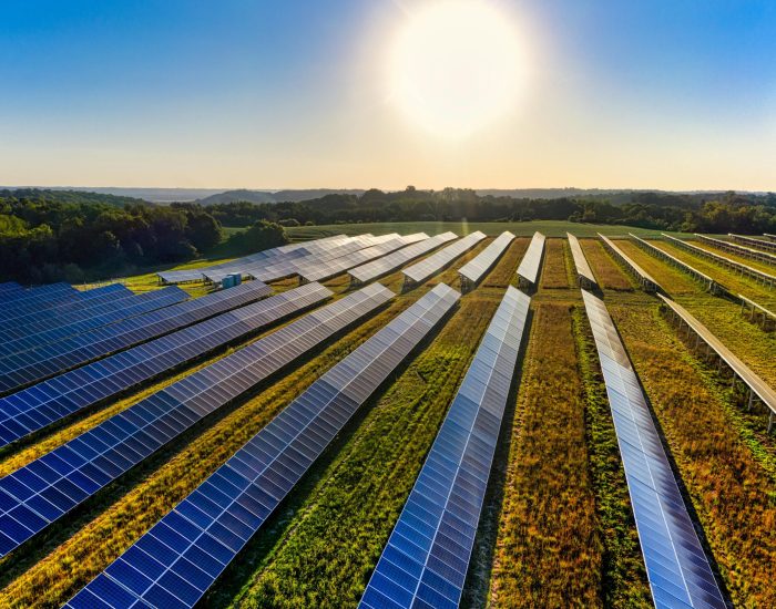 Aerial view of a solar farm in Red Wing, MN, with solar panels harnessing the sun's energy.