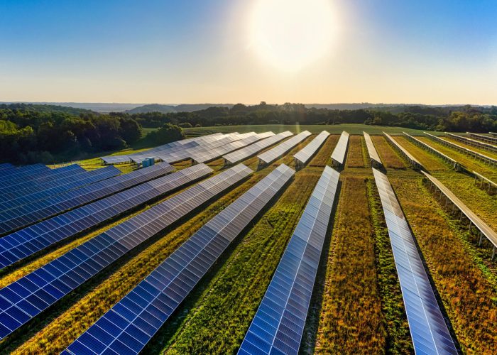 Aerial view of a solar farm in Red Wing, MN, with solar panels harnessing the sun's energy.